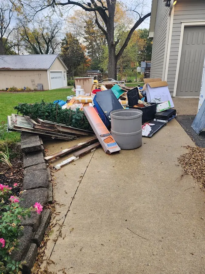 Dumpster being loaded with debris for 12 Yard Dumpster Rental in Fairview Shores
